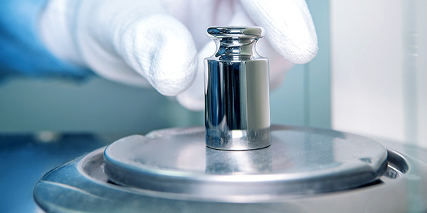 multi brand technician performing calibration on a scale mass instrument