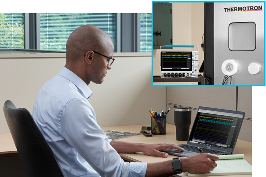 Engineer at his bench working space using remote software to control an oscilloscope and performaning measurements and analysis remotely